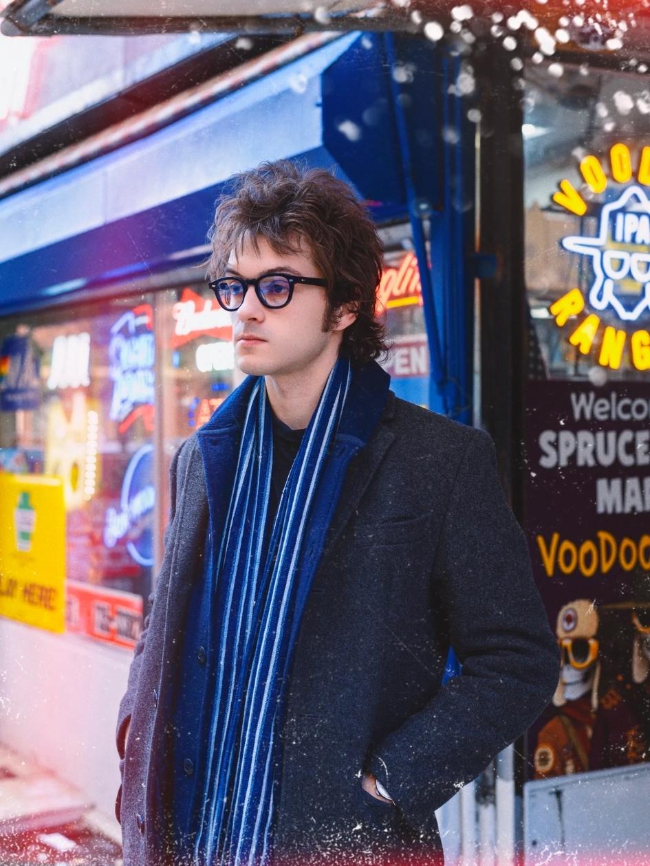 A person standing outside a store wearing the P3 Fulvue italy low bridge Tart Optical Frame.