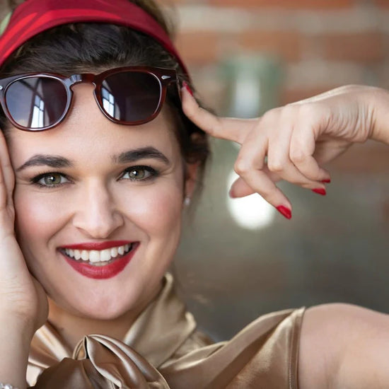 A person with a red headband wearing Tart Optical's frames.