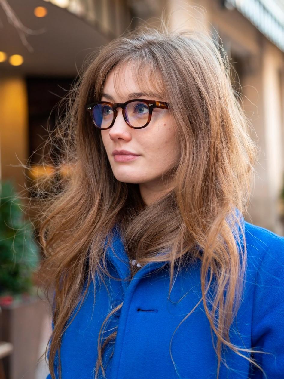 A person looking to the left wearing the P3 Fulvue Italy Low Bridge Tart Optical Frame. 